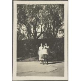 Two unidentified women and Lesley Brasch on pavement
