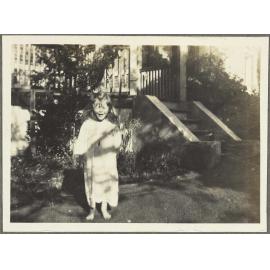 [Elespie Forsyth] standing on lawn in front of house