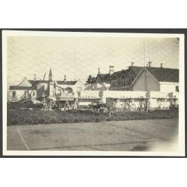 Buildings behind cage fence