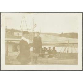 Two boys in front of ship