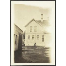 Boy on bicycle in front of Waitaki Boys' High School building