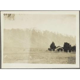 Paddock with snow-capped mountains in background