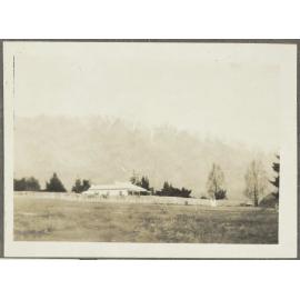 House with snow-capped mountains in background