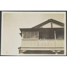 Looking up at verandah of wooden house