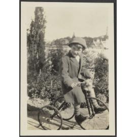 Unidentified child riding a tricycle