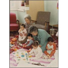Barbara and Eva, volunteer childcare workers, with children at the Otago Polytechnic Adult Learning Centre