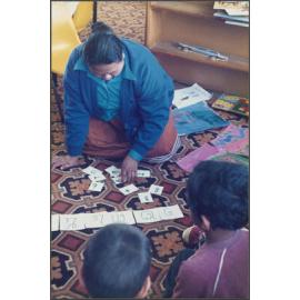 Cambodian parent teaching Khmer numbers to children at Arthur Street School