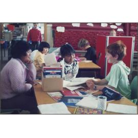 Adult English language teacher visiting primary school children