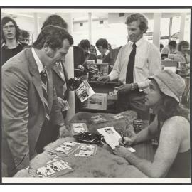John Clarke as Fred Dagg autographing his book, The Thoughts of Chairman Fred