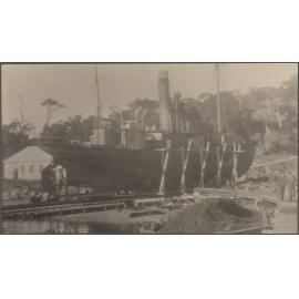 Ship undergoing repairs in dry dock