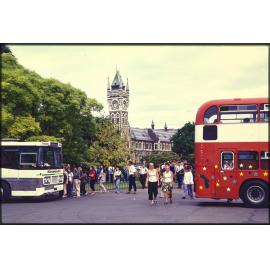 Tour buses at the University of Otago, with clocktower in background
