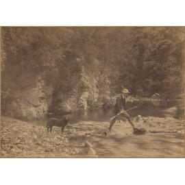 Man and dog crossing creek