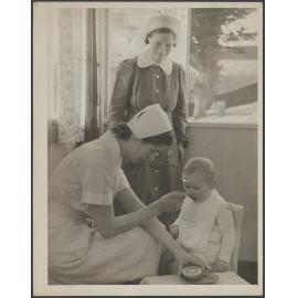 Nurse feeding baby
