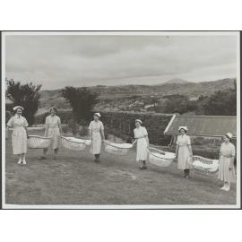 Nurses holding bassinets