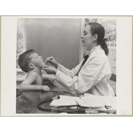 Doctor inspecting child's mouth