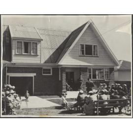 Crowd seated outside building