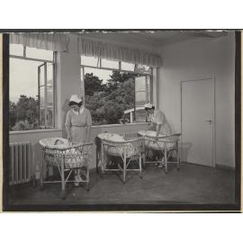 Nurses with babies in bassinets