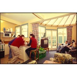 Students in kitchen and living area