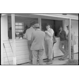 Men standing outside a canteen