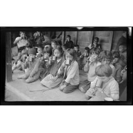 Children drinking from metal cups
