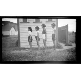 Four girls standing side on