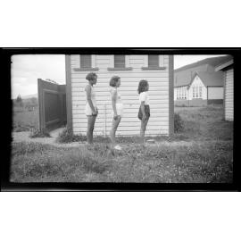 Three girls standing side on
