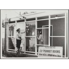 Mrs H. J. Ryburn and another woman cleaning the windows at the North East Valley Plunket Rooms