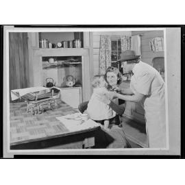 'Miss Alden immunising baby in the home'