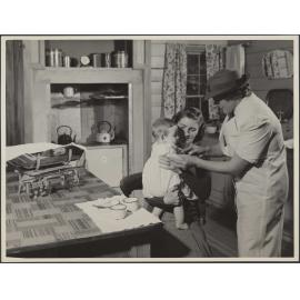 'Baby receiving immunization injection in the home'