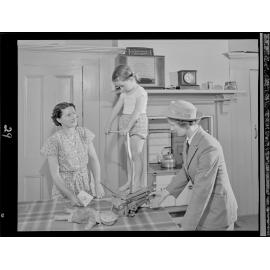 A nurse 'Weighing the Pre School child in the home'