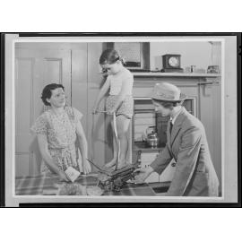 A nurse 'Weighing the Pre School child in the home'