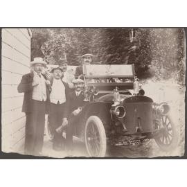 Five men sitting and standing by a car at Wairongoa Springs