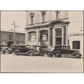 Taxis being washed outside Thomsons premises
