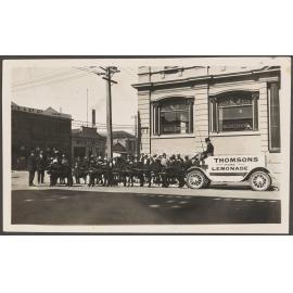 People gathered by Thomsons Lemonade pony-drawn wagon at the corner of Police and Crawford streets