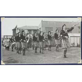 The Dunedin Ladies' Scottish Pipe Band  marching into the Caledonian Ground