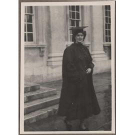 Brenda Slade dressed in academic regalia outside the Senate House, Cambridge