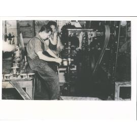 Canning whitebait, putting on lids